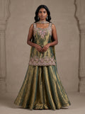 Model wearing olive green tissue silk embroidered sharara set with metallic gold sheen and matching dupatta